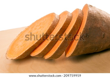 Sweet potato over a wooden board / sweet potato
