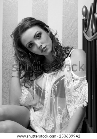 pretty woman lying on a bed in black and white / Woman