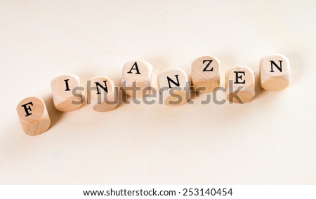 wooden cubes with the german word finance / Finance