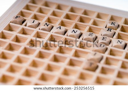 small wooden cubes with the german words Finance and Credit / Finance and Credit
