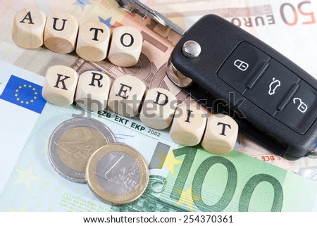 Euro Money and wood cubes with the german words car loan / car credit