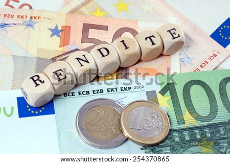 Euro Money and wood dice with the german word return on / Rendite