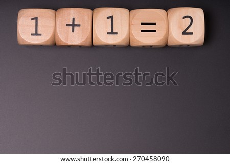 Wooden cube with one plus one equals two / one plus one equals two