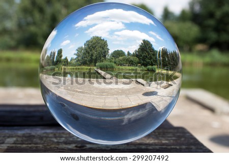 Glass sphere picture in nature with blue sky / Glass ball