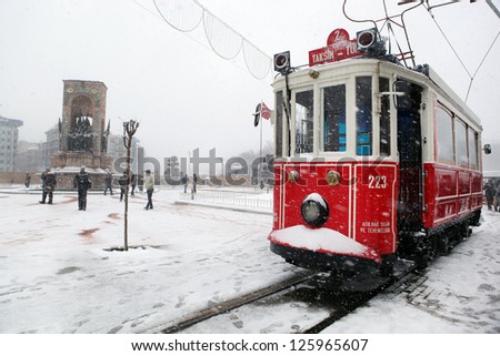 ISTANBUL,TURKEY-JANUARY 8: Unidentified pedestrians walk down Istiklal Street on a snowy day on January 8, 2013 in Istanbul, Turkey.Istiklal Street is one of the popular destinations in Istanbul.