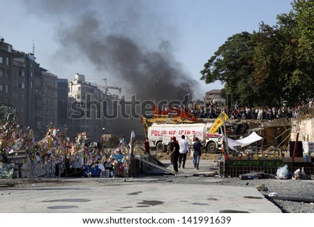 ISTANBUL,TURKEY-JUNE 11:Police attack Taksim protesters with tear gas and water cannons on june 11, 2013 in Istanbul,Turkey.Clashes continued all day between police and demonstrators.