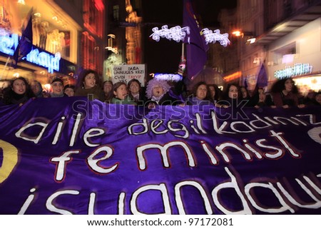 ISTANBUL,TURKEY-MARCH 8: Unidentified women in purple costume celebrates international women\'s day on March 8,2012,in Istanbul,Turkey