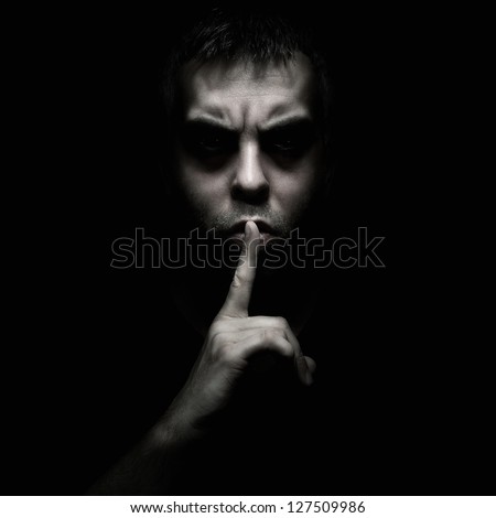 Evil Man Gesturing Silence, Quiet Isolated On Black Background
