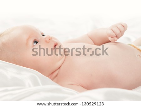 Close up of cute baby girl with funny face expression isolated on white background