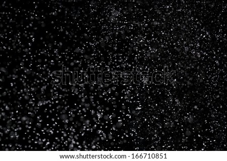 Winter background. falling snow isolated on pure black background