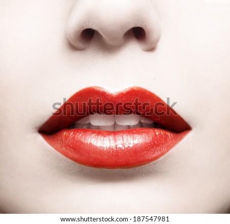 Close up of beautiful red glossy female lips