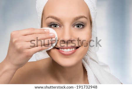 Happy attractive women removing makeup in the bathroom Happy attractive women removing makeup in the bathroom