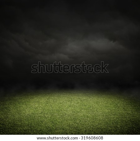 Soccer or football field at night with copy space