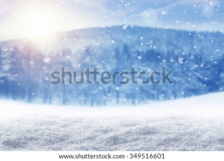 Winter background, falling snow over winter landscape with copy space