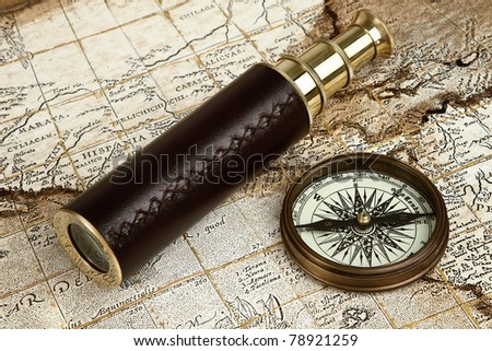 Vintage brass telescope on antique map with copy space