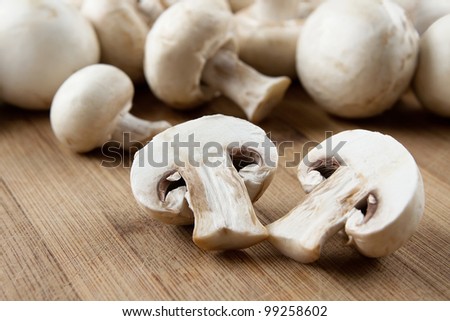 Fresh sliced mushrooms at wooden cutting board