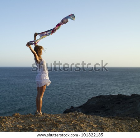 woman flying a handkerchief on the beach
