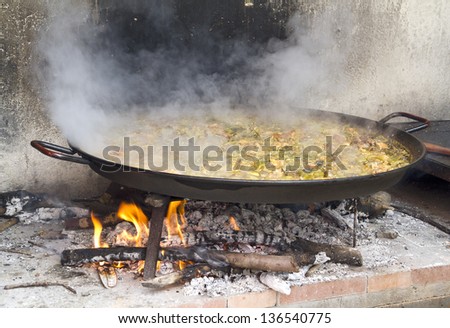 Typical Spanish paella cooked over a wood fire