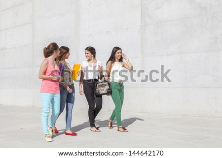 group of teenagers having fun walking on the street