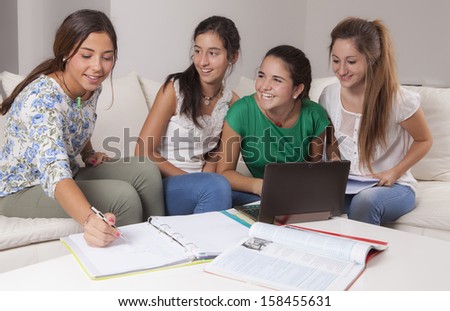 Young university studying together, in a room with a sofa and a table