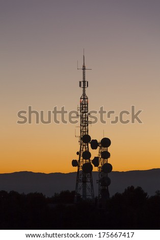 telecommunications antennas silhouettes, backlit