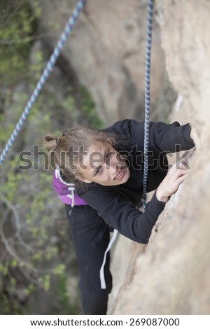 woman climbing a hard wall