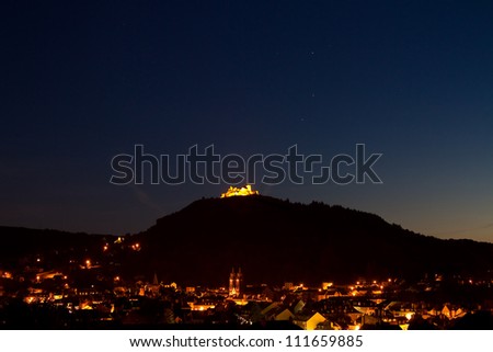 overview of Espalion at night with the castle Calmont d\'Olt in the background