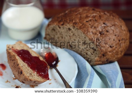 Bread, jam and glass of milk on the blue napkin. Blurred background. I hope you find this image useful, and if you download it, thank you for your support!