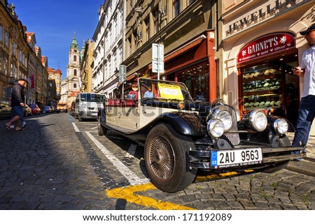 PRAGUE - SEPTEMBER 10: Sightseeing tours on vintage car in old prague on September 10, 2012 in Prague, Czech Republic.
