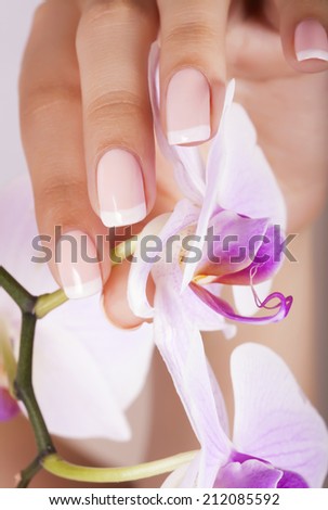 Beautiful woman\'s nails with french manicure.
