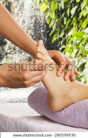 Foot massage in the spa salon in the garden.
