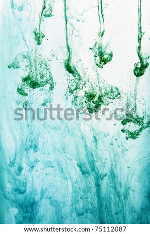 Green watercolor paint in the water