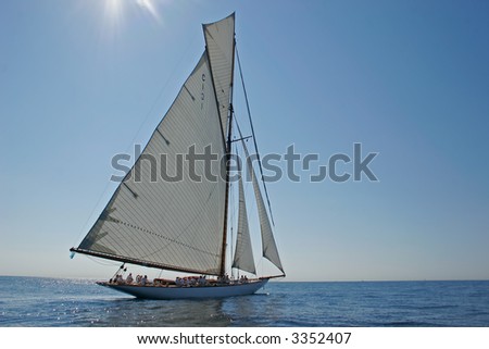 Old sailing boat all sails outside on the sea
