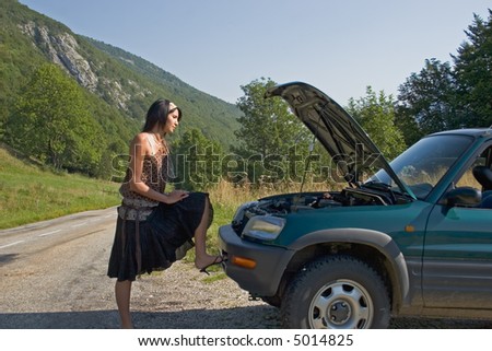 Woman breaking down of car