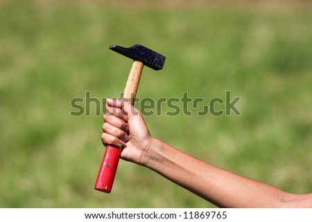 Feminine hand holding a tool