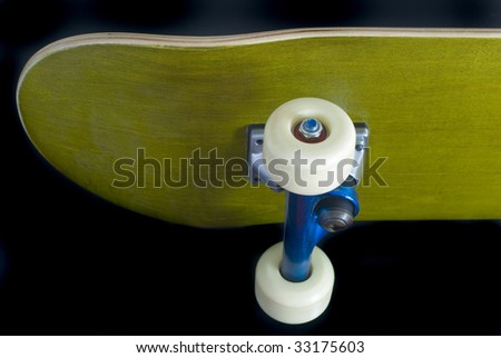 underside of a skateboard deck with blue metallic trucks