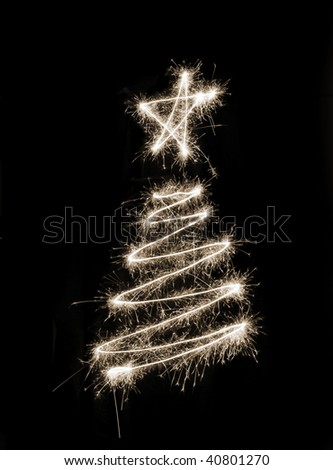 A christmas tree symbol drawn in sparkler trails