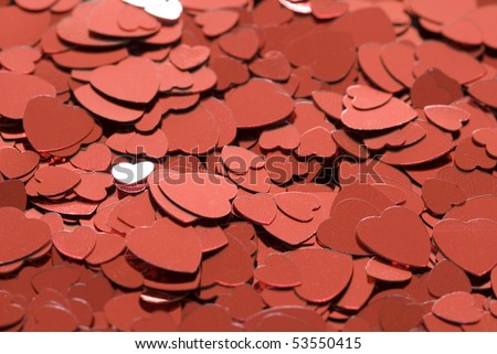 a background of red metallic love heart shaped confetti