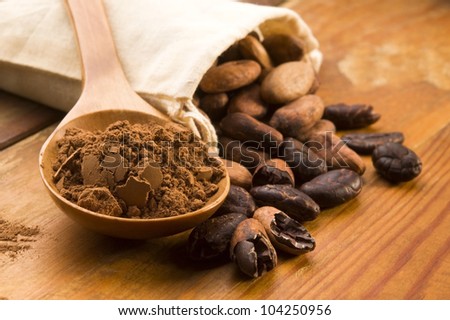 Cocoa (cacao) beans on natural wooden table