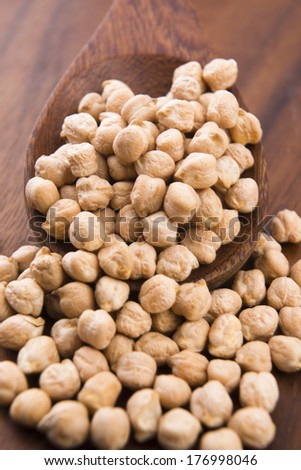 dried white chickpeas ceci on the wooden spoon