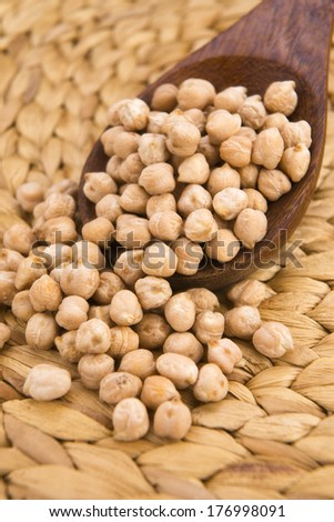 dried white chickpeas ceci on the wooden spoon