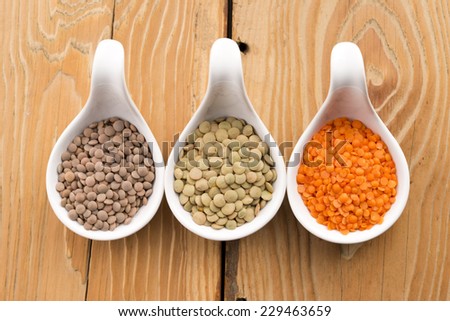 Three kinds of lentil in bowls - red lentil, green lentil and brown lentil