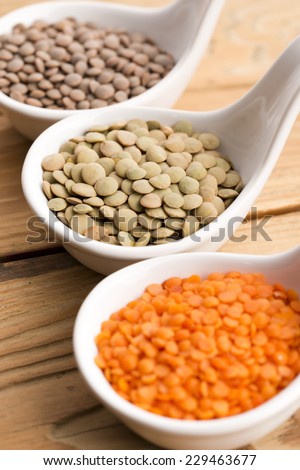 Three kinds of lentil in bowls - red lentil, green lentil and brown lentil