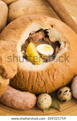 traditional white borscht (zurek) with sausage,egg and mushrooms in bread as bowl