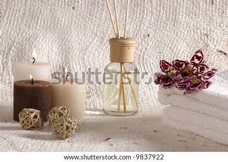 aroma therapy objects. bottle of esential oil, candles, bath-salt, towels, orchid