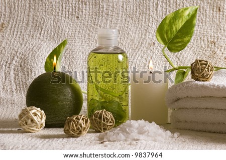 aroma therapy objects. bottle of esential aroma liquid, candle, towels, bath - salt