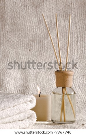 aroma therapy objects. bottle of esential oil, candle, towels