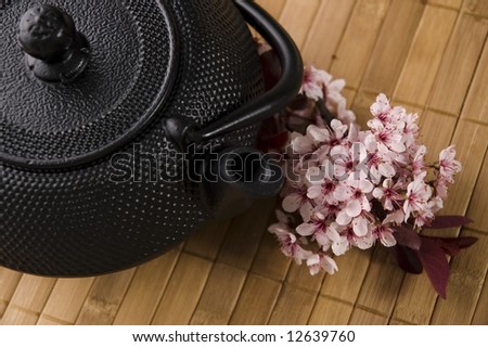 teapot with a fresh flowers on the bamboo tray