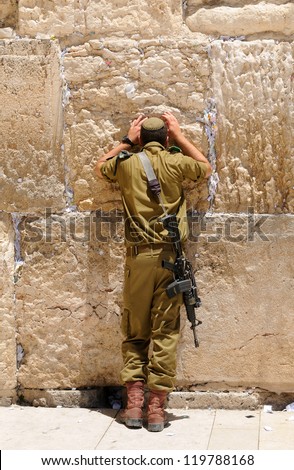 A soldier prays in the Western Wall kotel A soldier prays in the Western Wall kotel