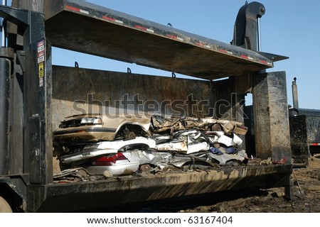 Damaged squashed cars in a junk yard